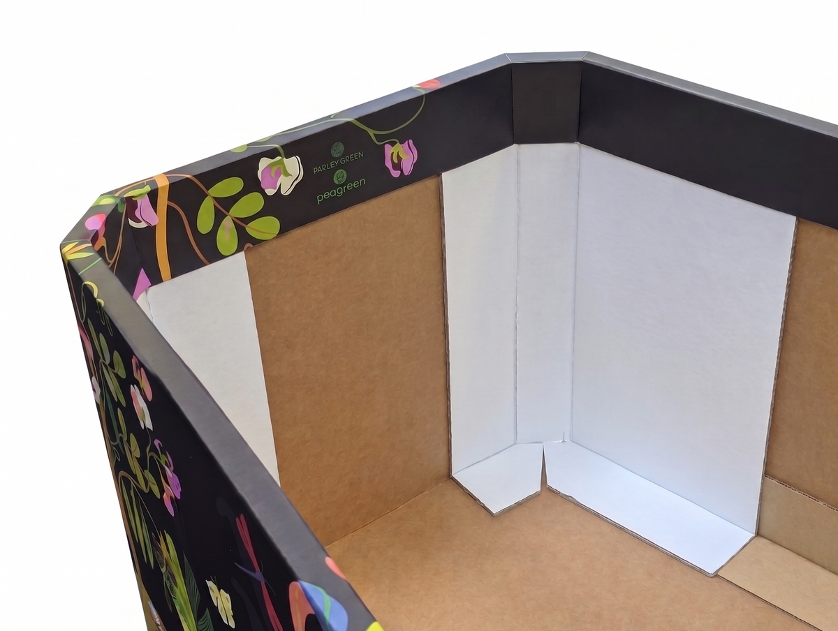 A corner modular of cardboard coffin, featuring a black outer border decorated with colorful floral and leaf patterns, and white inner panels.