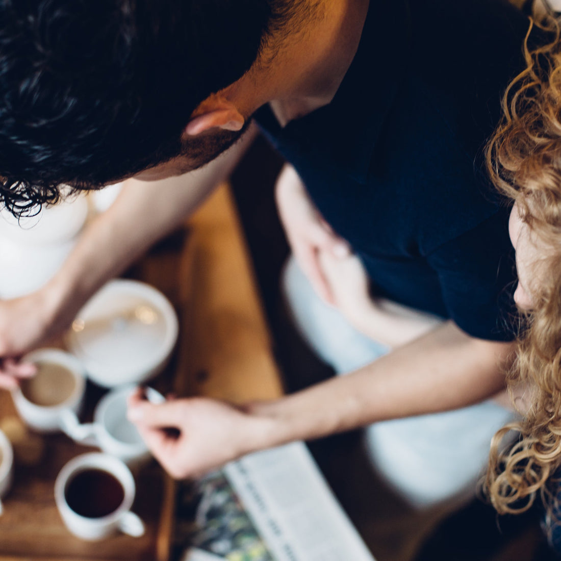 Two people preparing coffee in a kitchen setting